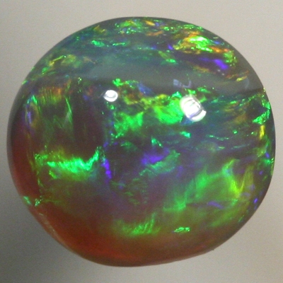 SOLID BLACK CRYSTAL OPAL Bright greens rolling flashes over a high dome